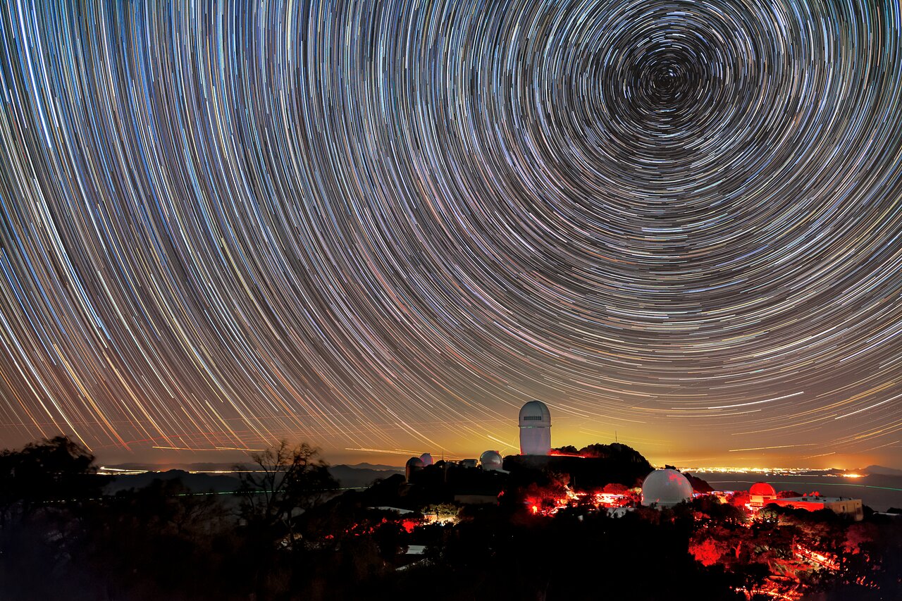 Nighttime view of KPNO. The yellow glow on the horizon comes from Tucson, Arizona, about 90 kilometers (55 miles) to the northeast. Over the past decade, light pollution like this has increased by 2% a year from many medium-sized and larger cities.