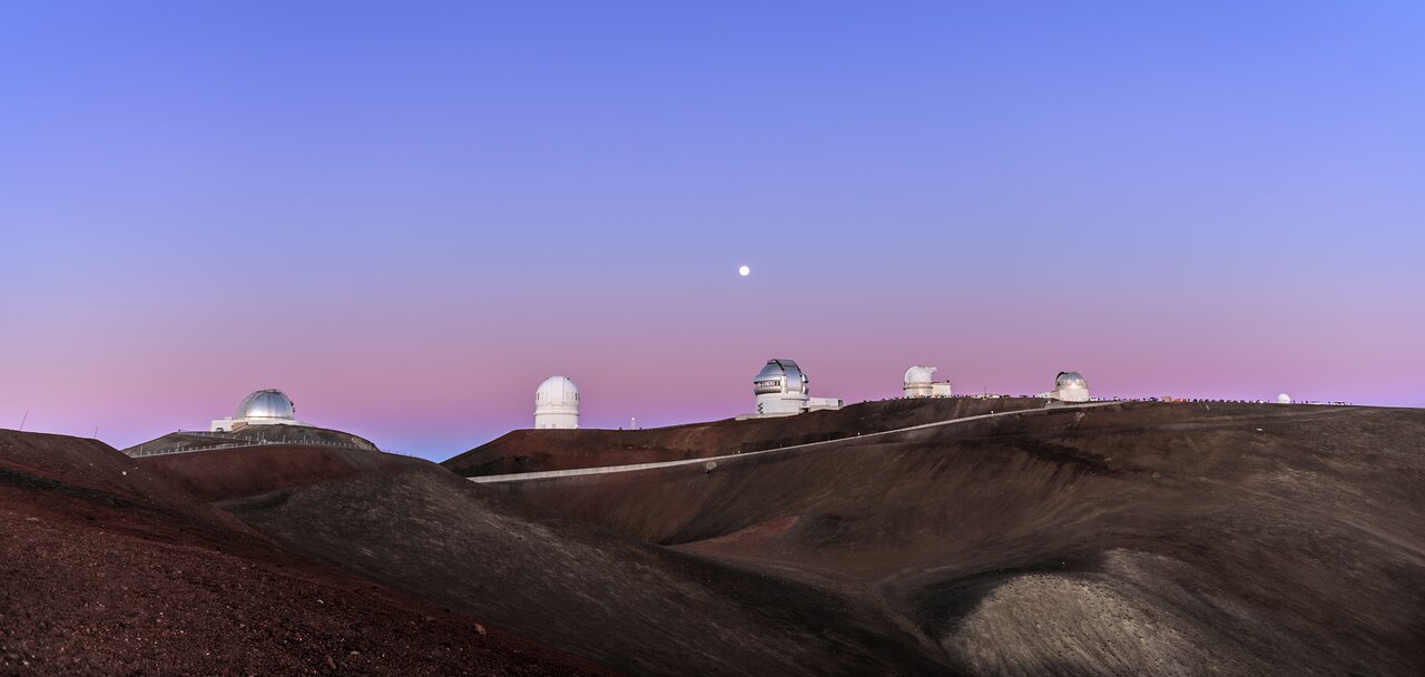 View of several of the telescopes on Maunakea. Construction of the first telescope on the site began in 1967 and it hosts multiple observatories which are operated by a variety of consortia of organizations spanning the globe. 