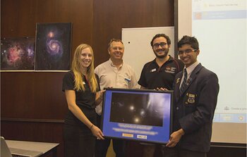 Student winner and mentors with the winning image