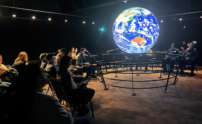 Project ASTRO teachers and astronomers enjoying a Science on a Sphere show in the McMath Pierce Solar Telescope.