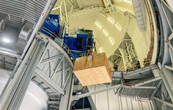 The 3000-kilogram special instrument container with parts of GPI inside being lowered onto the transport truck using the special dome crane.