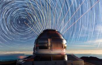 Timelapse of the night sky over Gemini North, part of the International Gemini Observatory, operated by NSF NOIRLab, showing star trails and multiple views of the laser guide star.